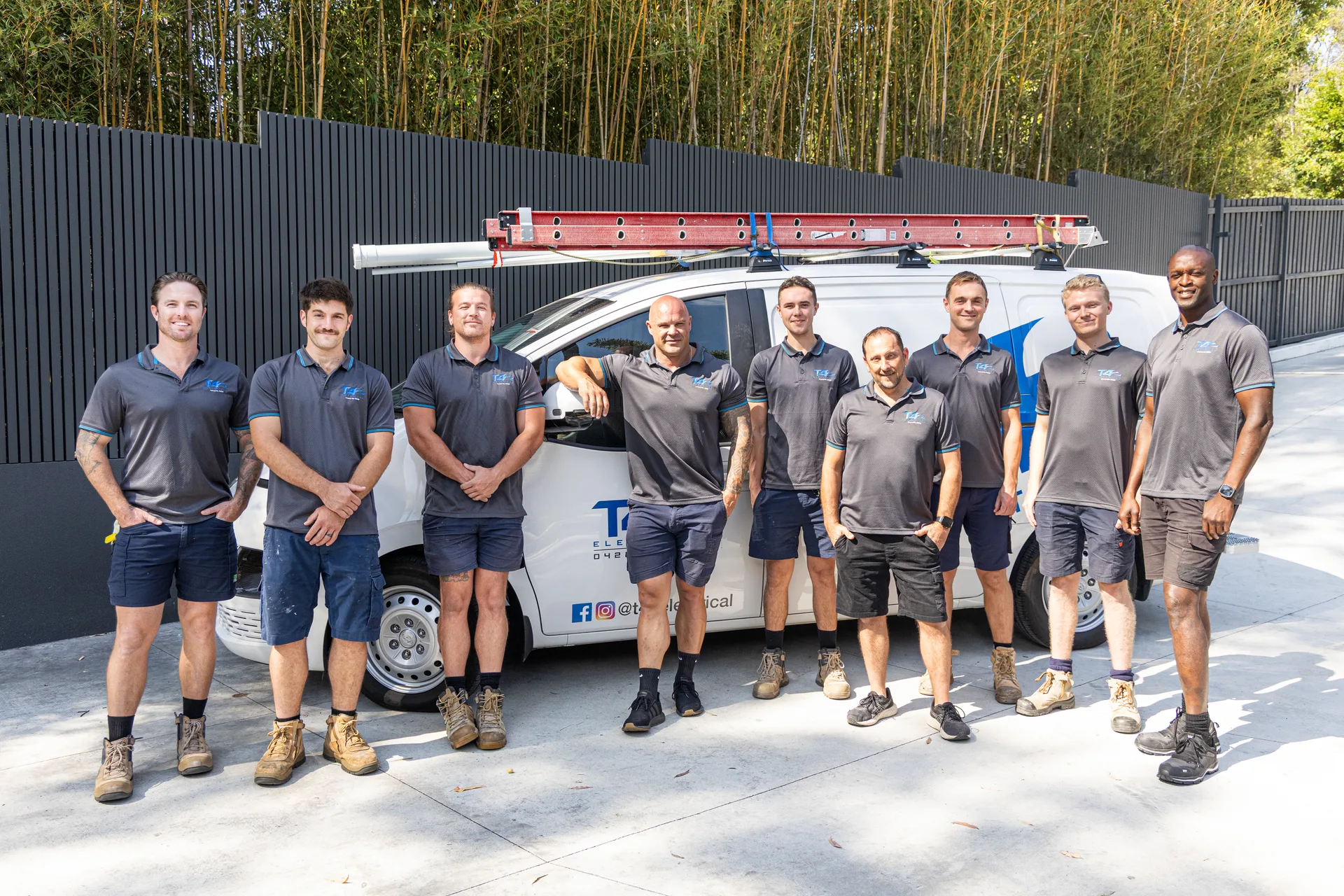 The Family Electrician Helensvale team with a service van